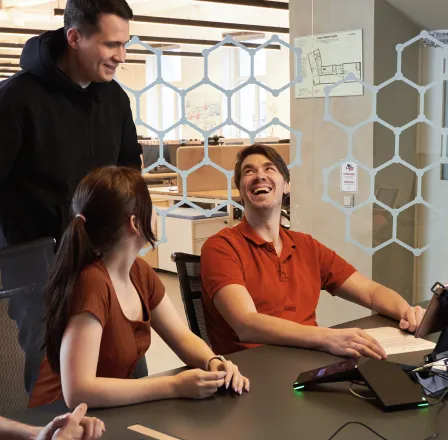 Team members have a happy discussion during an office meeting