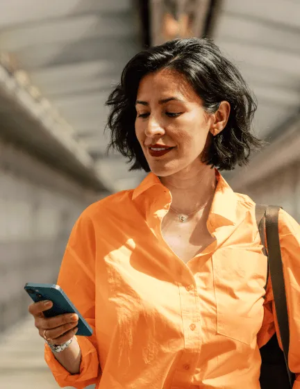 A woman sending an SMS from her mobile phone